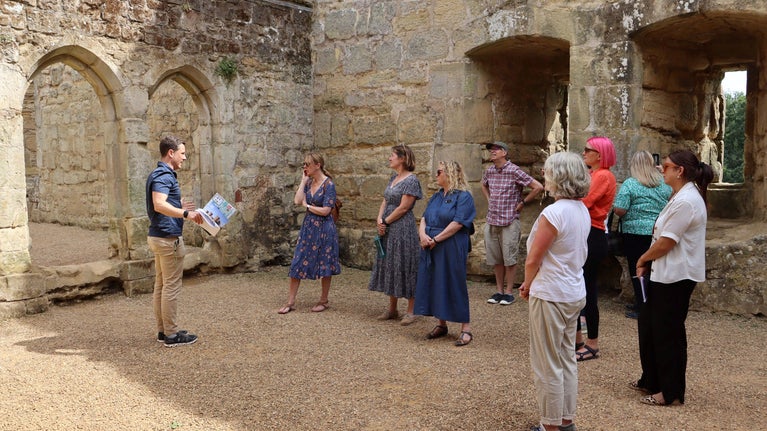 A group of people standing inside the castle
